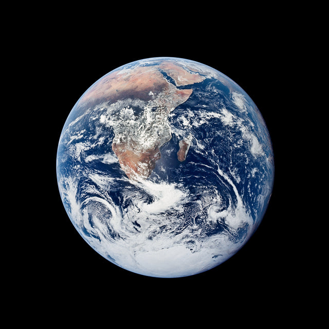 Earth viewed from orbit, the fragile blue marble against the blackness of space that triggers the Overview Effect in astronauts