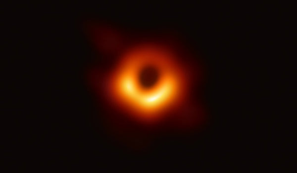 First image of a black hole, captured by the Event Horizon Telescope in 2019, showing the glowing orange ring of superheated gas around the dark shadow of M87 star
